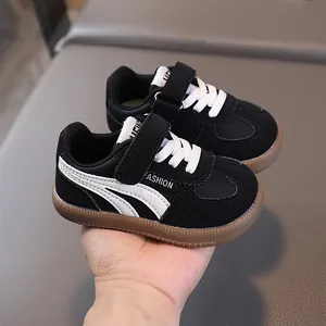 Kids black leather athletic sneakers with non-slip rubber soles and velcro straps