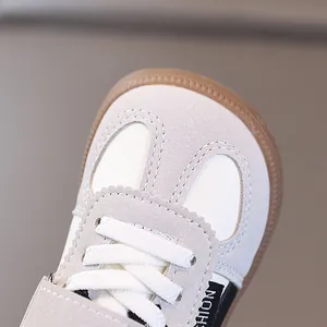 Detailed close-up of premium children's leather German trainer shoes with soft soles