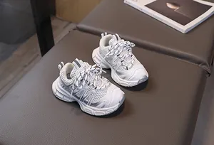 Détail de baskets respirantes pour enfants avec semelles épaisses en blanc et argent