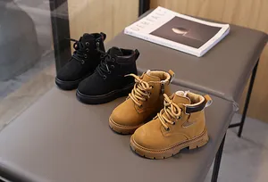 Detailed view of children's leather boots with side zipper and thick non-slip rubber soles