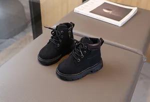 Detail view of children's black matte leather boots with side zipper and rubber sole