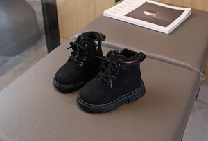 Detail view of children's black winter boots with thick warm plush lining and side zipper