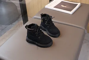 Detail view of black kids' boots with side zipper and durable anti-slip rubber sole