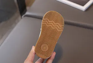 Detail of baby shoe gum rubber sole with wavy anti-slip grip and size 23 mark
