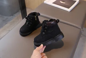 Detail of warm black kids' winter boots with thick plush lining and side zipper closure