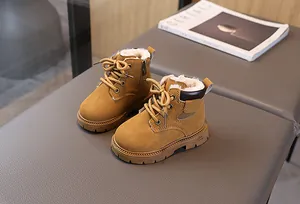 Detail of warm plush lining and sturdy anti-slip sole on children's winter yellow boots