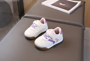 Detail of toddler sneakers with purple velcro strap and durable brown rubber sole