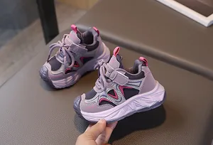 Detail of purple girl's sports sneakers with velcro strap and chunky cushioned sole