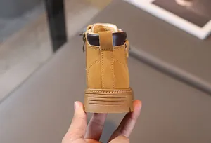 Close-up of yellow leather kids boot featuring anti-slip rubber sole and side zipper