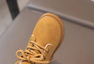 Detail of warm faux fur lining and premium nubuck leather on kids winter martin boots