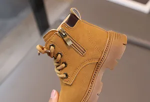Detail view of yellow leather kids boots with metal side zipper and sturdy rubber sole