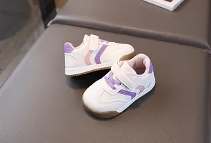 Close-up of baby sneakers with pink wavy lines, gum sole and velcro strap closure