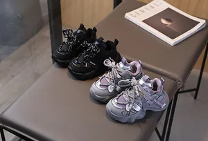 Detail of kids chunky sneakers featuring mesh leather patchwork and fashion webbing