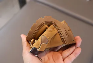 Detail showing the flexible gum rubber sole of yellow children's Martin boots