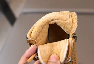 Close-up of children's tan winter boots showing the thick warm fleece lining and side zipper
