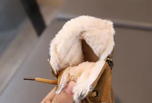 Close-up of thick faux shearling lining and bronze zipper on children's winter boots