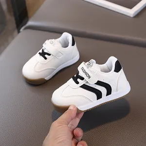 Toddler white sneakers with black stripes and non-slip rubber soles for boys and girls