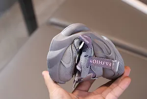Macro detail of toddler purple sneaker showing exceptional sole flexibility and soft material