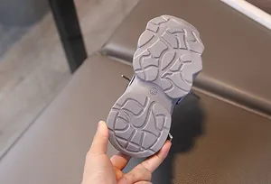 Detail of durable non-slip rubber sole on children's sneakers with size 28 marking