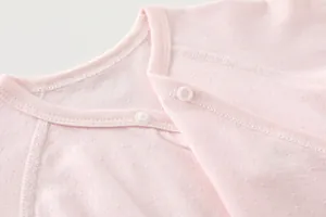Macro detail of breathable bamboo fiber fabric and snap buttons on baby romper