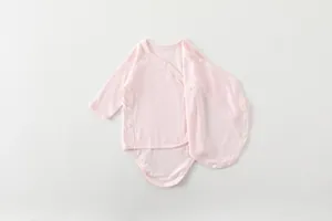 Detail of baby pink long-sleeve bodysuit with side snaps and soft bamboo texture