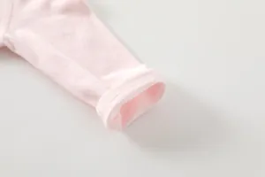 Close-up of baby romper pink sleeve cuff showing breathable bamboo fiber texture