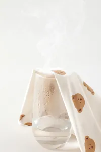 Breathable cotton baby bodysuit fabric with cartoon bear print showing steam ventilation
