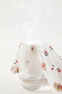 Breathable cotton baby fabric with bear and cherry prints showing steam penetration