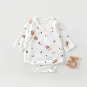 Close-up of baby bodysuit with cherry bear print and soft side-tie closure design