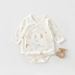 Detail of newborn cotton bodysuit featuring cute bear prints and side-tie closure