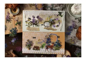Adesivi PET vintage con fiori e animali mostrati in una scena di scrapbooking creativa
