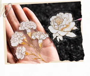 Detail of floral stickers with laser gold edges and transparent carnation designs
