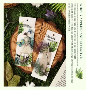 Detailed view of vintage botanical stickers with ferns and butterflies on wood