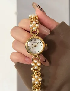 Macro detail of GEDI vintage gold floral bracelet watch with pearl inlay and shell dial