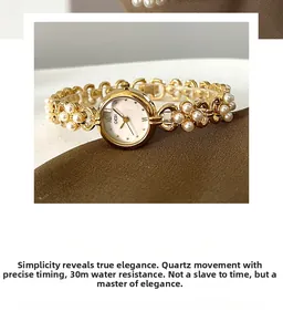 Close-up of golden quartz watch featuring white pearls and 30m water resistance