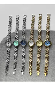 Detail of luxury women's quartz watches featuring pearl chains and colorful dials