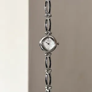 Elegant silver women's watch featuring a mother of pearl dial and stylish hollow link band