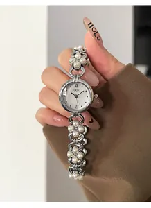 Detail of silver floral metal watch strap with pearls and GEDI brand logo dial
