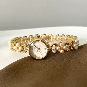 Elegant GEDI gold watch for women featuring white pearl chain strap and Roman numeral dial