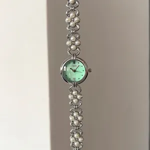 Elegant silver flower bracelet watch with green pearl dial and pearly floral metal links