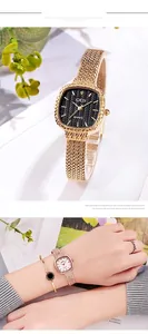 Detail of square quartz watches with mesh straps and an elegant matching gold bracelet