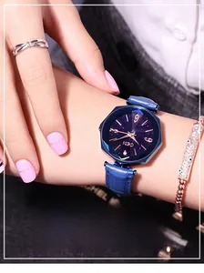 Close-up of women's octagonal starry sky watch with blue leather strap and rose gold markers
