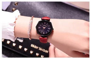 Close-up of red leather watch with starry starry dial and evil eye bracelet
