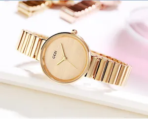 Close-up of champagne gold minimalist ladies watch with sleek bamboo-style metal band