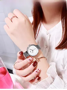 Elegant women's quartz watch with silver bamboo strap and matching jewelry set worn by model