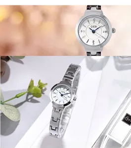 Detail of elegant silver quartz watch with white dial and diamond-like markers for women
