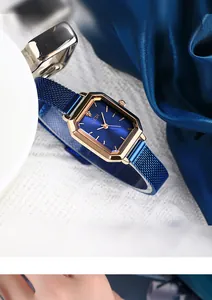 Close-up of a women's vintage square watch with blue sunray dial and rose gold case