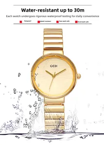 Gold quartz watch with bamboo-style mesh strap showing 30m water resistance in splashing water