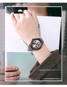 Close-up of GEDI fashion watch with dark grey dial and brown leather strap on wrist