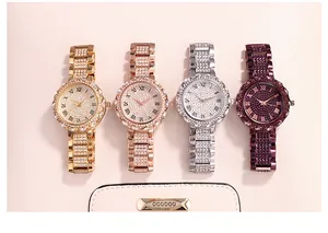 Close-up of four luxury crystal-studded quartz watches in gold, silver, and rose gold